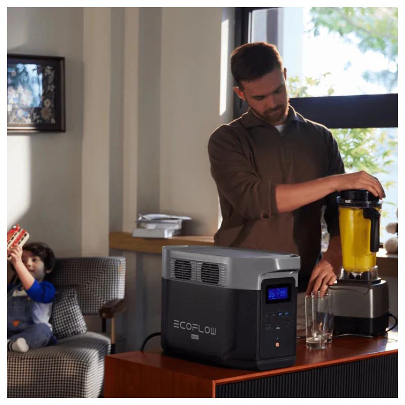 Man using a blender with a portable power station in a home setting