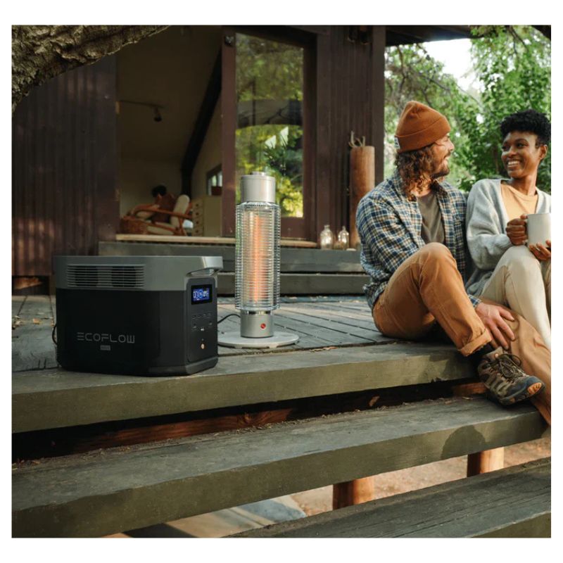 Two people sitting on a wooden deck with outdoor heaters and a EcoFlow DELTA 2 Max Portable Power Station