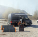 Jackery Explorer 1000 Plus Portable Power Station beside a caping van with people.