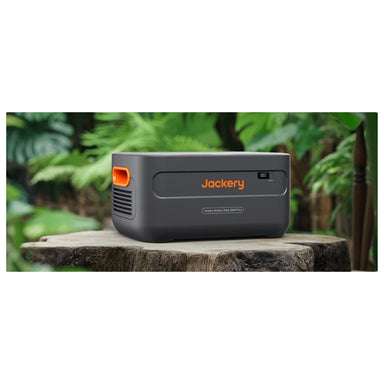 Jackery Battery Pack 2000 Plus on a tree stomp