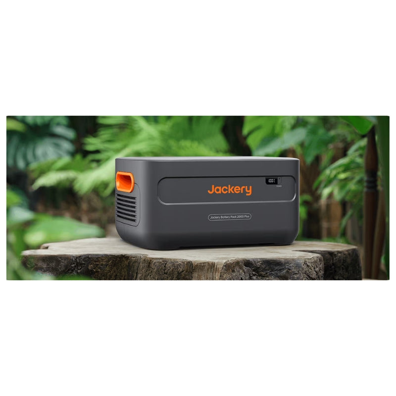 Jackery Battery Pack 2000 Plus on a tree stomp