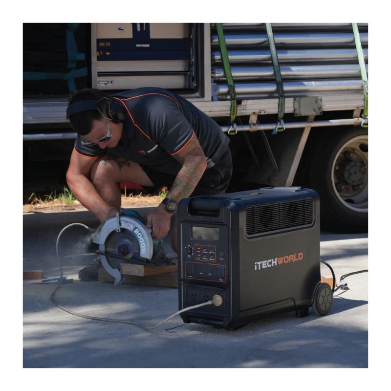 Person using a PS3600 Pro portable power station with a circular saw, with a truck in the background.