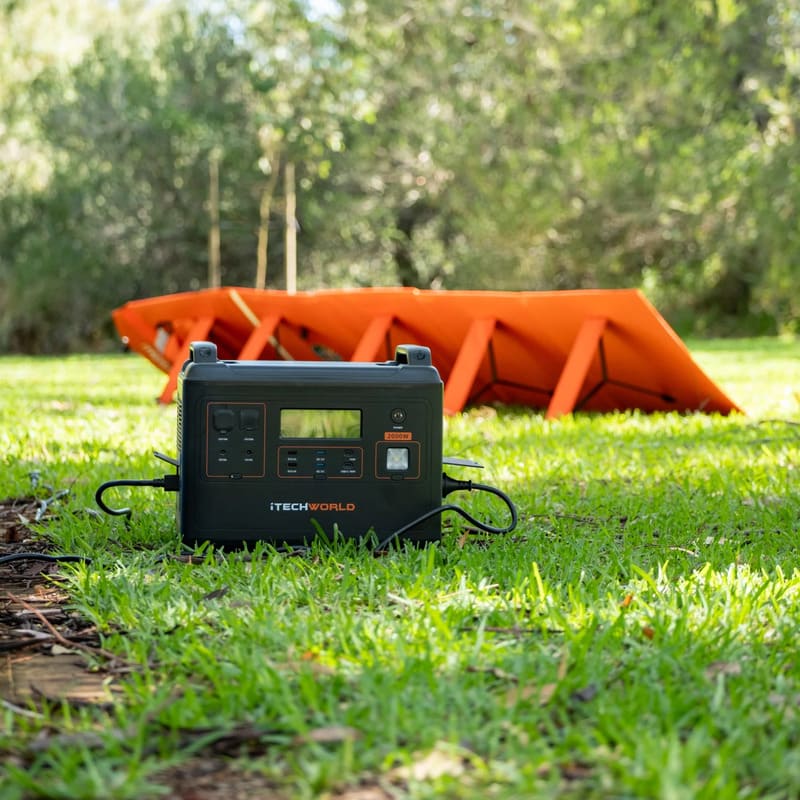 iTechworld Elite Solar Generator Kit - PS2000 Power Station and 200W Solar Blanket on a lawn.
