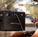 iTechworld Premium GoFurther Dual Battery System with iTECHDCDC40 Battery Charger and iTECH160X PRO Lithium Battery with Bluetooth - battery kit attached connected to a smartphone.